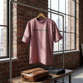 Best Quote Printed Cotton Candy Oversize T-shirt For Men's Pink t-shirt with 'COMPLICATED' text on a hanger against a brick wall.