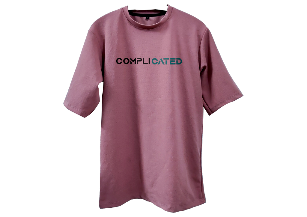Pink t-shirt with 'COMPLICATED' text on a white background