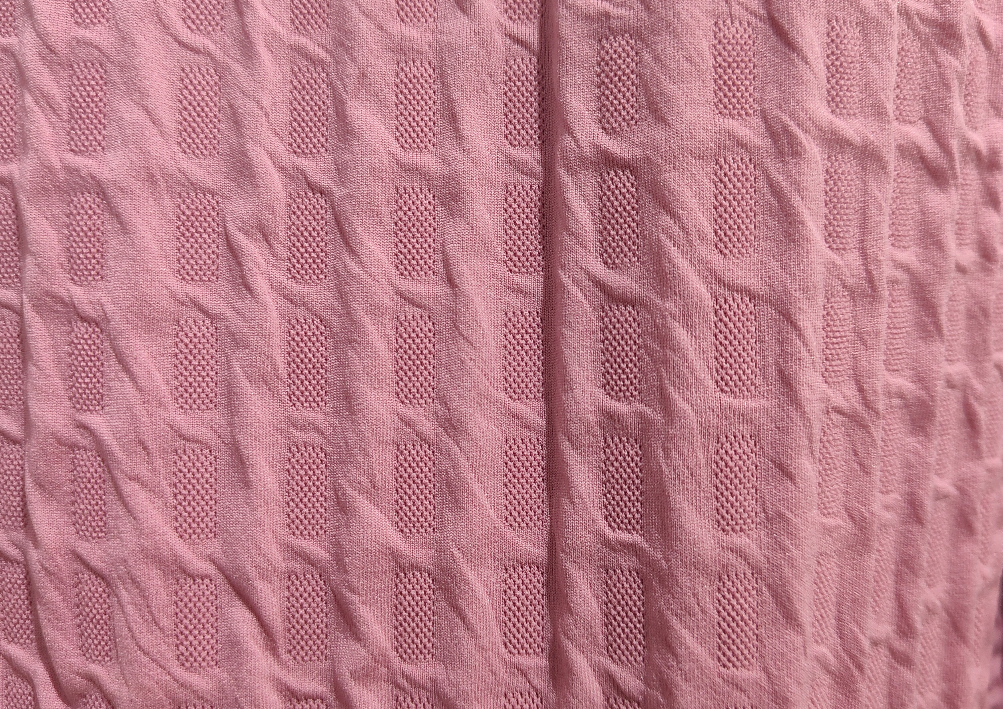 Man wearing a patterned beige shirt on a brown background