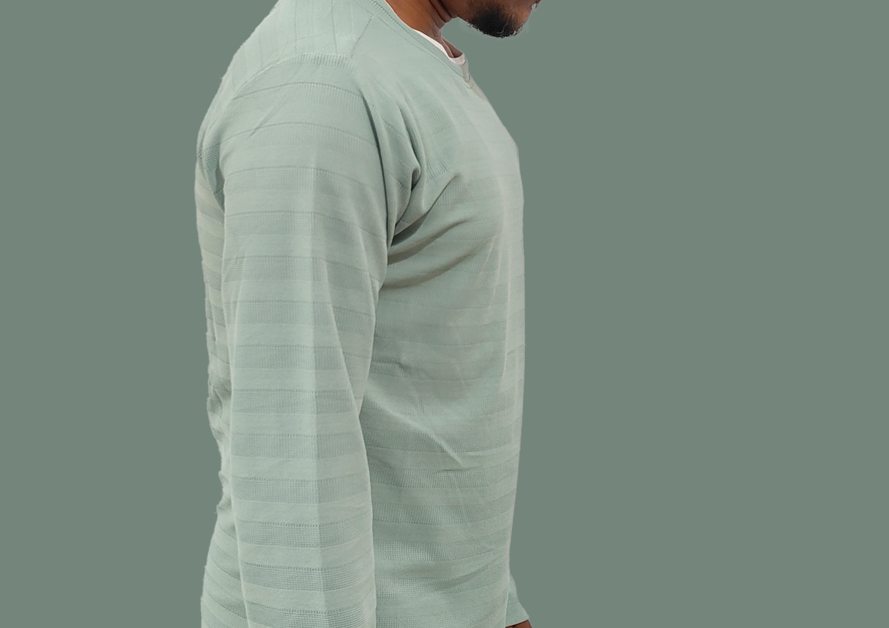 Man wearing a light gray long-sleeve shirt on a gray background
