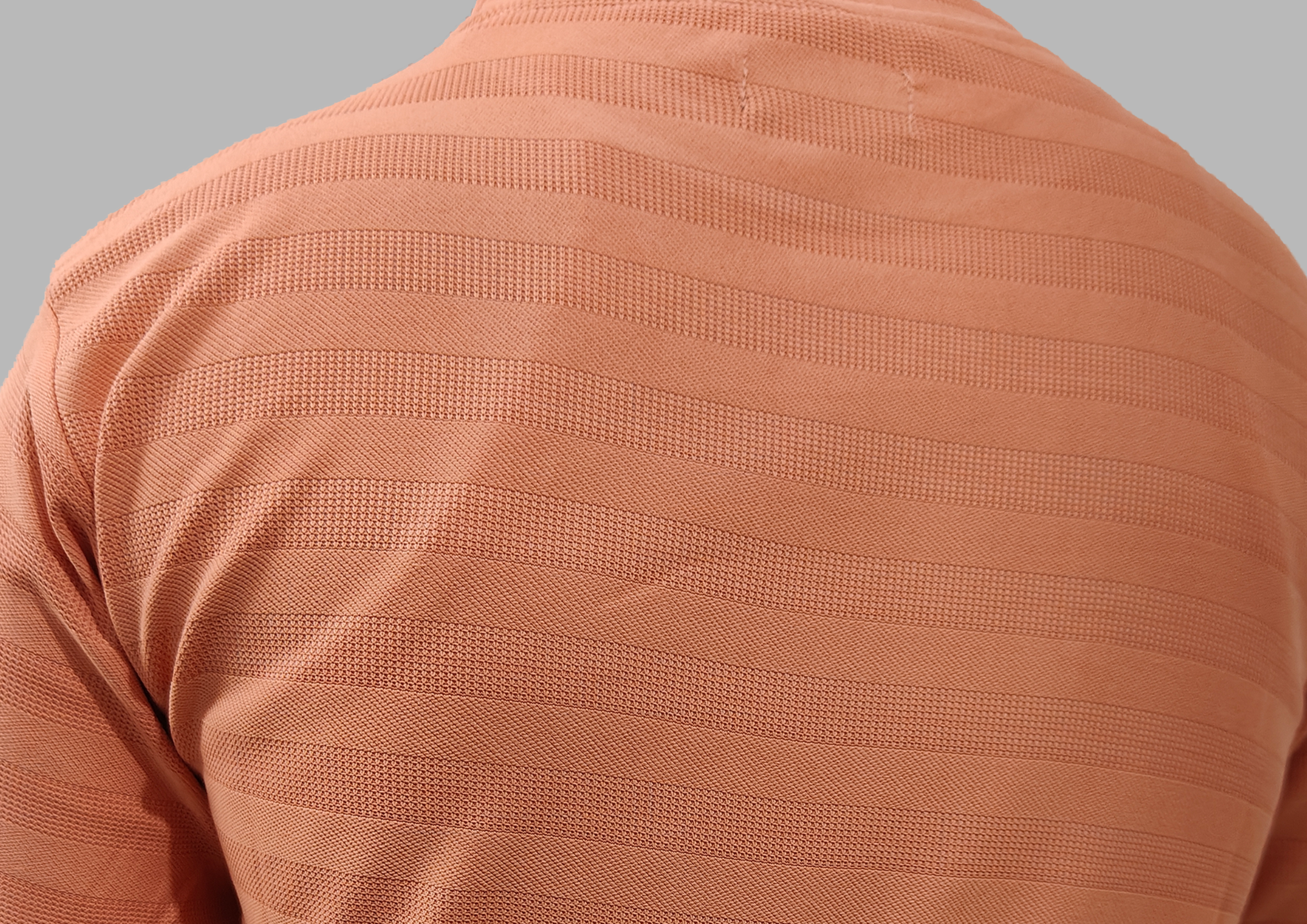 Close-up of a textured brown garment on a gray background