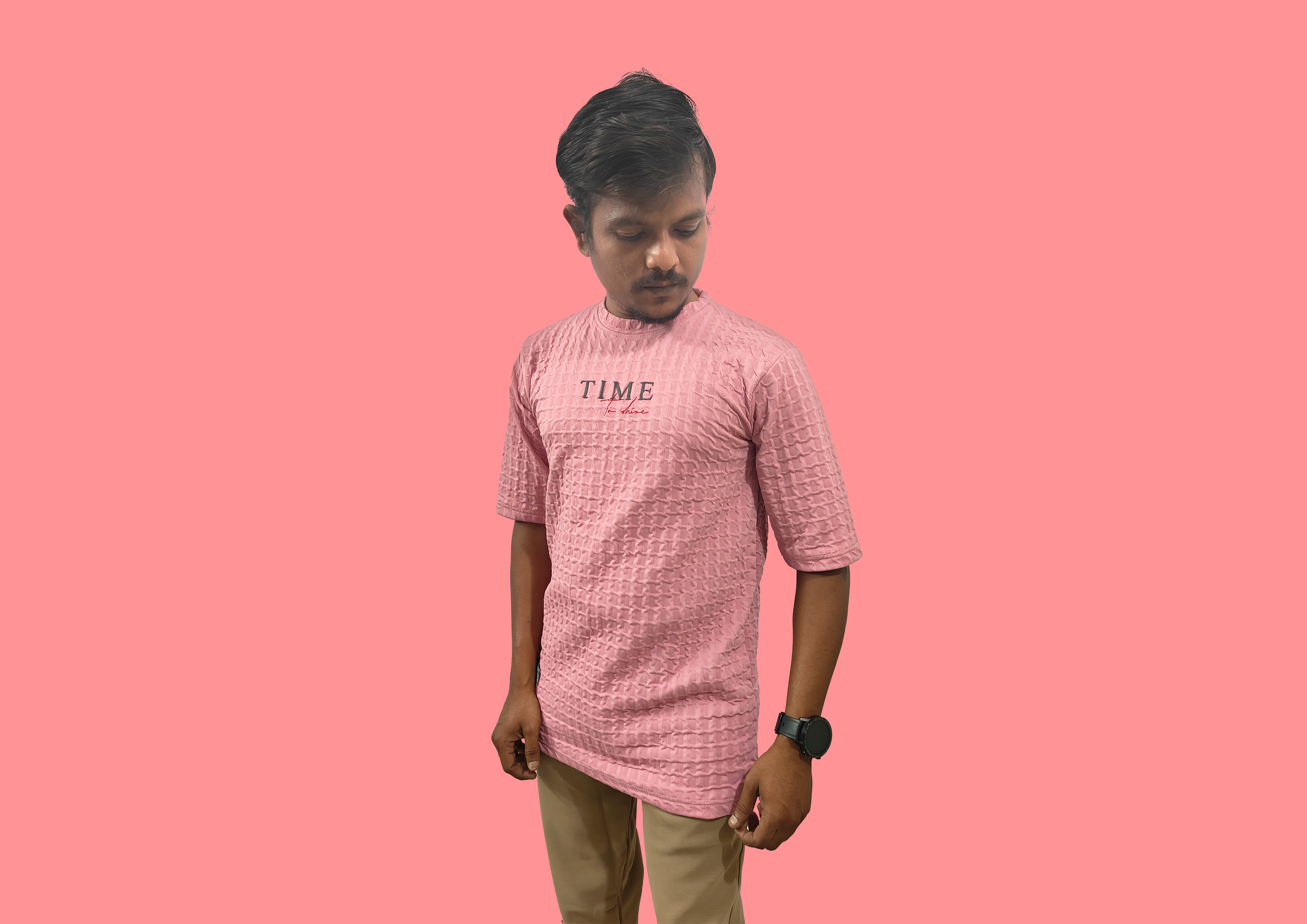 Man wearing a textured beige shirt against a brown background