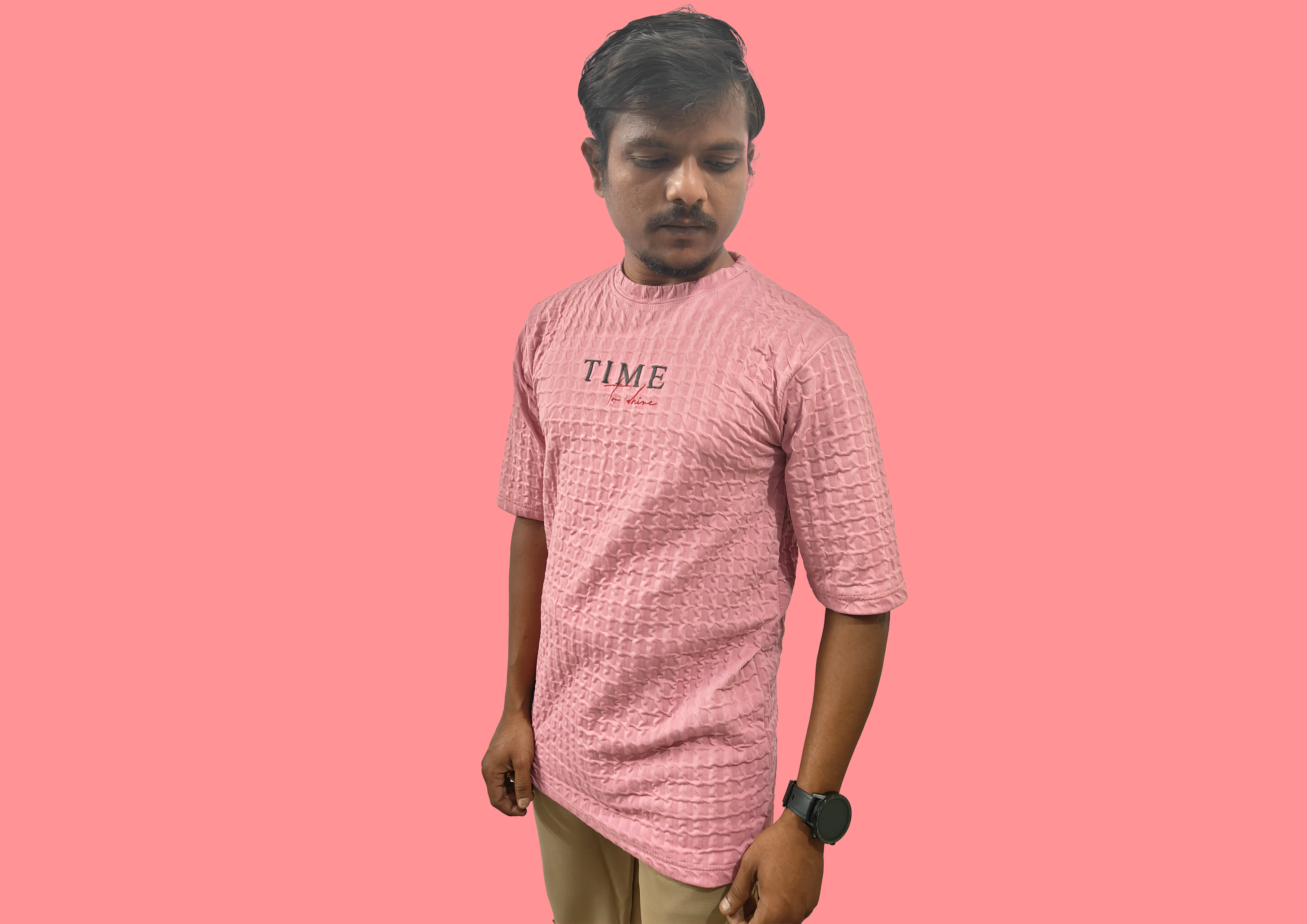 Person wearing a textured beige kurta against a brown background